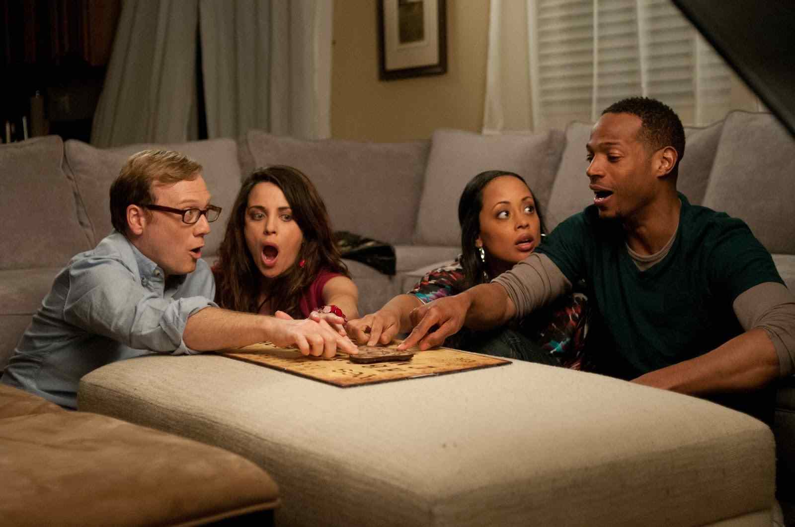 Malcolm and girlfriend Kisha and Jenny and Steve do an ouija board to try and contact the demon in a Haunted house directed by Michael Tiddes.